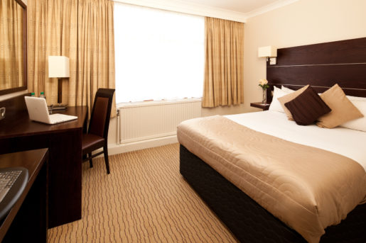Double bed, table and chairs in a classic room at Mercure Bradford Bankfield Hotel