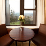 Table and chairs in front of a window overlooking the grounds at Mercure Bradford Bankfield Hotel