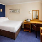 Double bed and desk in a classic room at Mercure Bradford Bankfield Hotel
