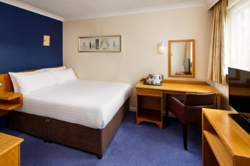 Double bed and desk in a classic room at Mercure Bradford Bankfield Hotel