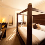Double bed, table and chairs in a superior room at Mercure Bradford Bankfield Hotel