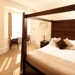 Double bed, table and chairs in a superior room at Mercure Bradford Bankfield Hotel