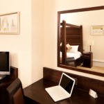 desk and tv in a superior room at Mercure Bradford Bankfield Hotel