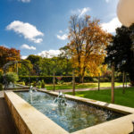 Shot of mercure bradford bankfield's luscious green garden with pond and fountain