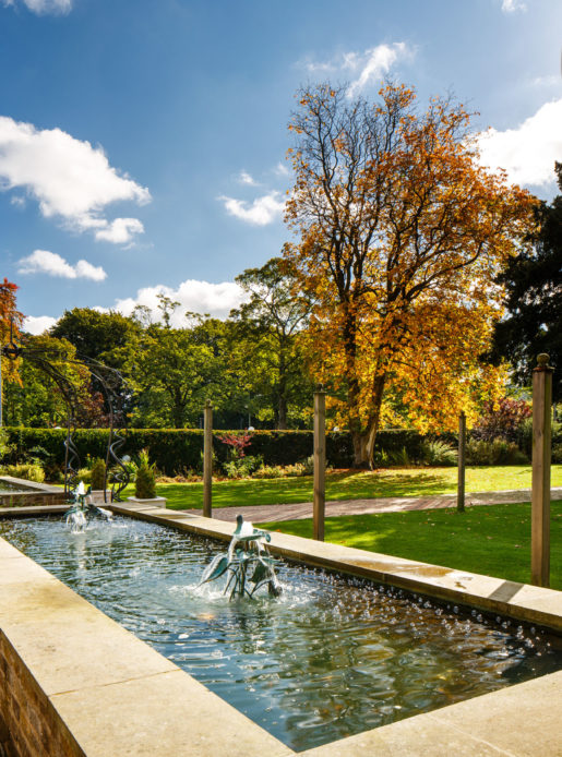 Shot of mercure bradford bankfield's luscious green garden with pond and fountain