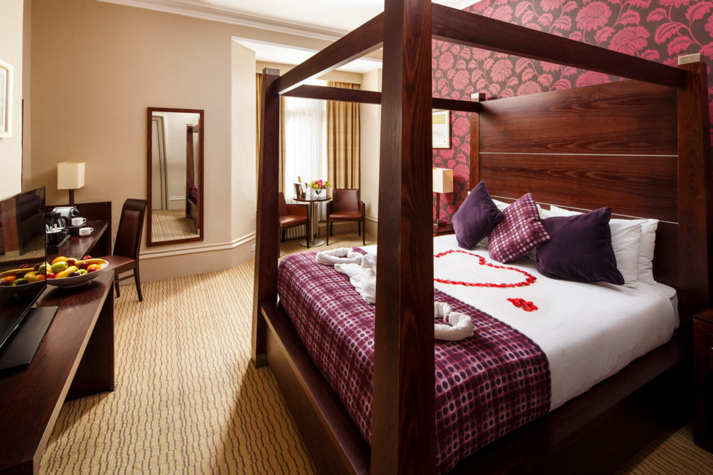 Mercure-Bradford-bankfield-hotel-wedding-superior-room-01-lr Privilege room with dark wood 4 poster bed with red rose petals formed on the bed for the happy couple