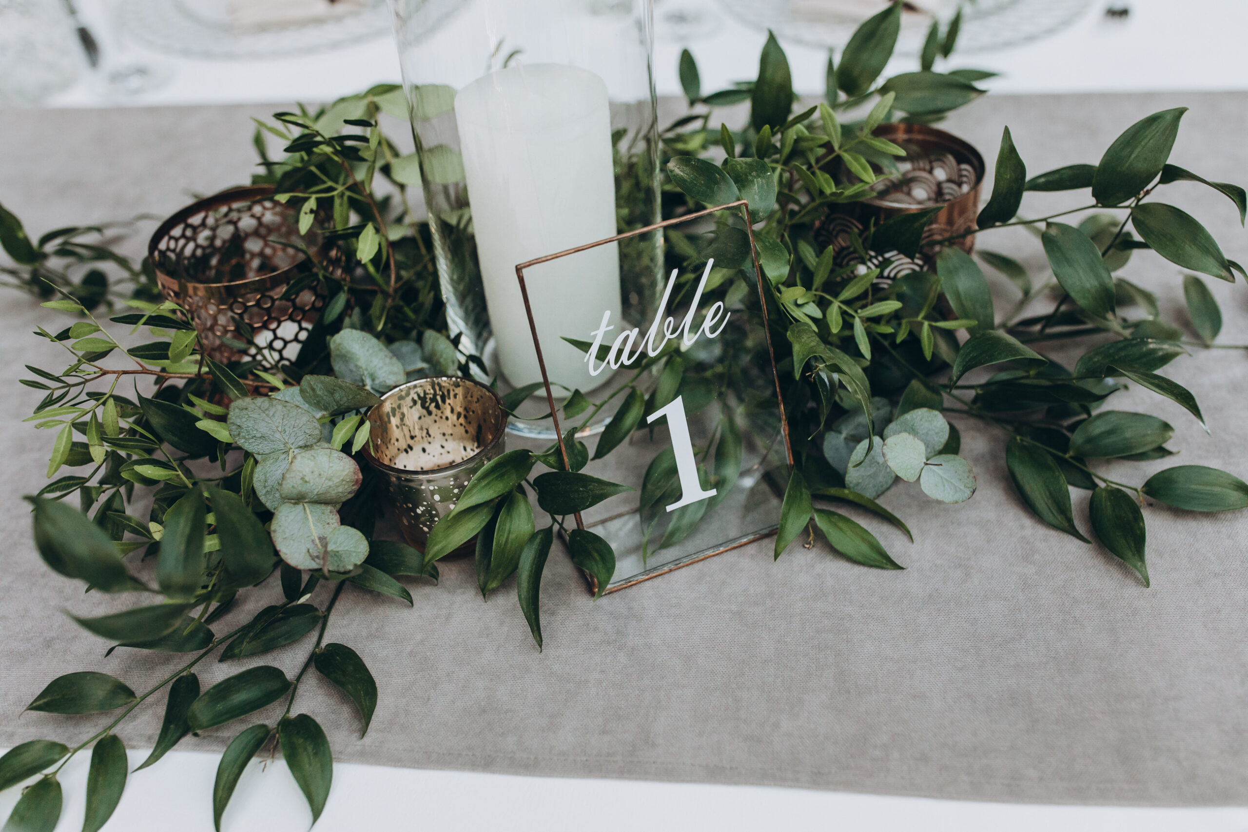 On,Table,With,Gray,Tablecloth,Is,A,Candle,In,Candlestick,